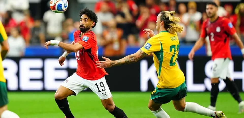 Player in red chasing the ball during match