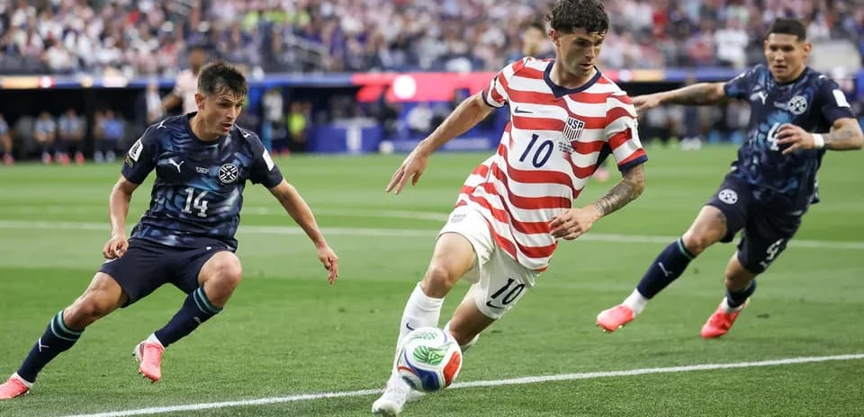 Player in striped jersey dribbling past opponents