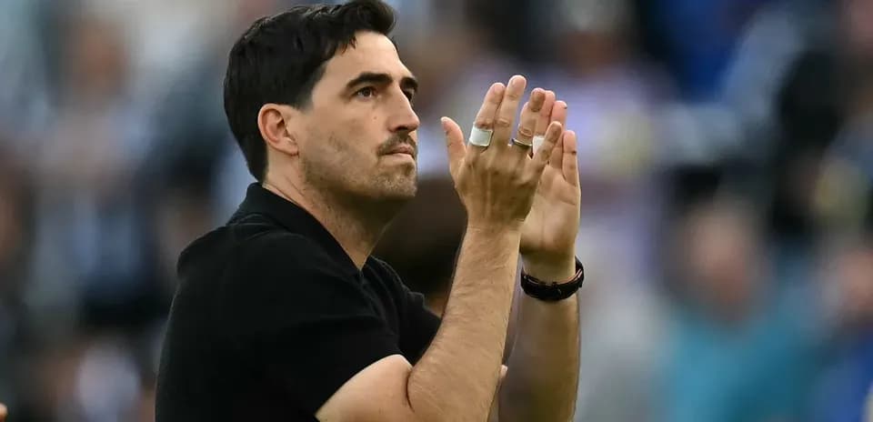 Coach applauding during match at stadium