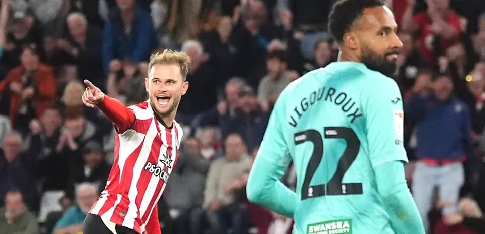 Player celebrating a goal against Swansea City goalkeeper