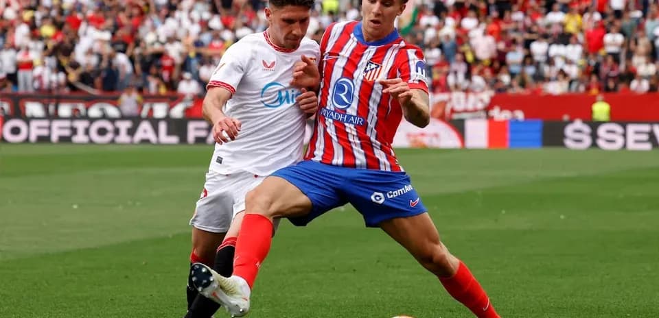 Sevilla and Atletico Madrid players battling for the ball