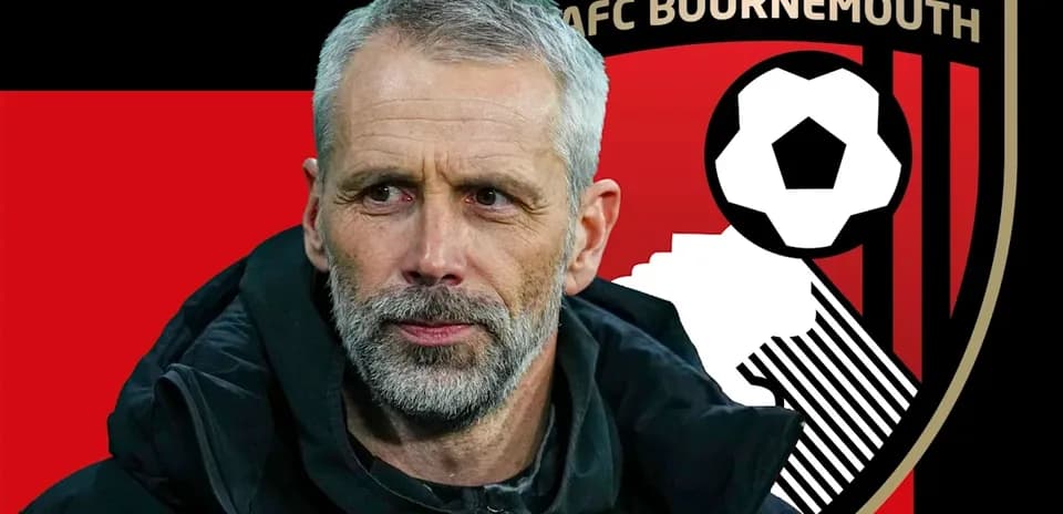 AFC Bournemouth manager in front of club logo