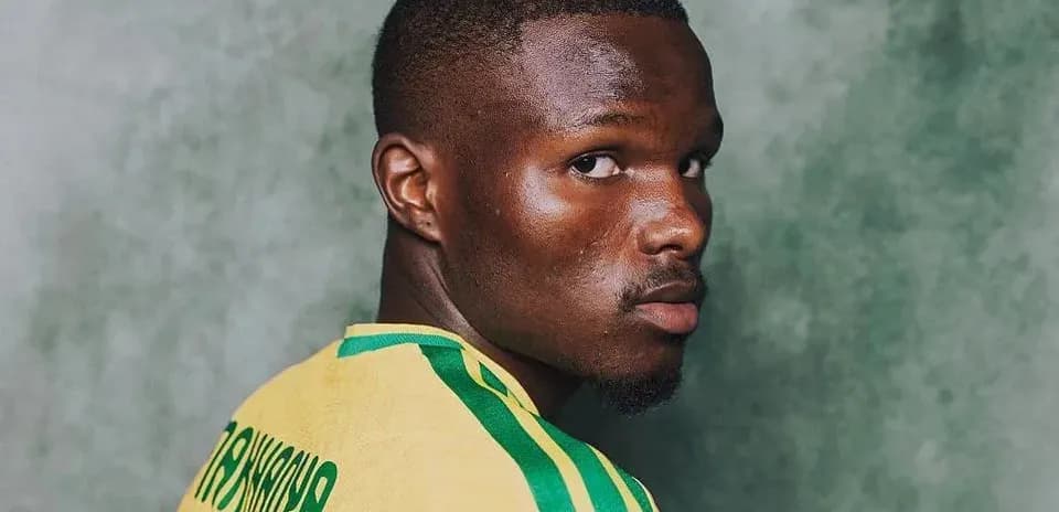 Player wearing a yellow jersey, looking over shoulder