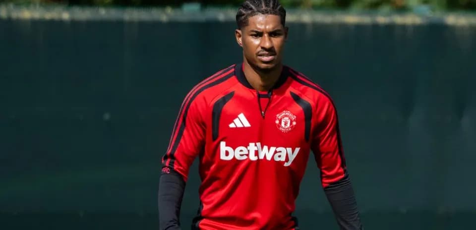 Player training in Manchester United kit on pitch