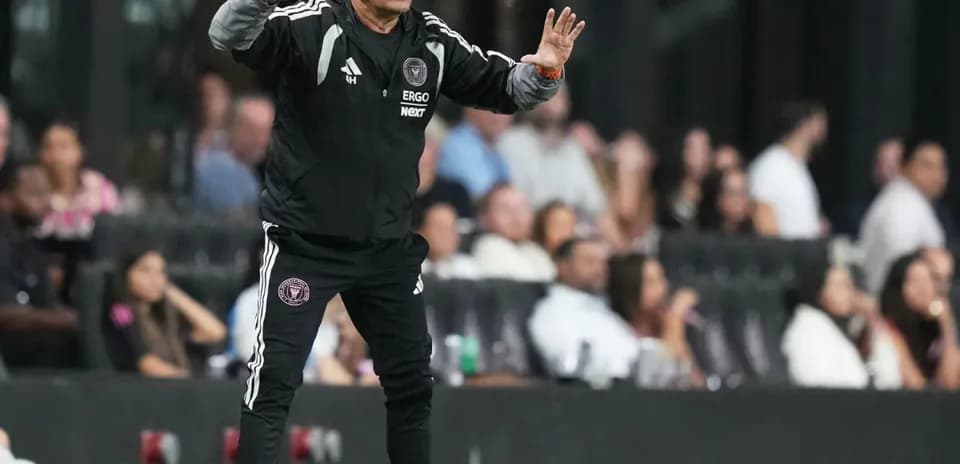 Coach gesturing from the sideline during match