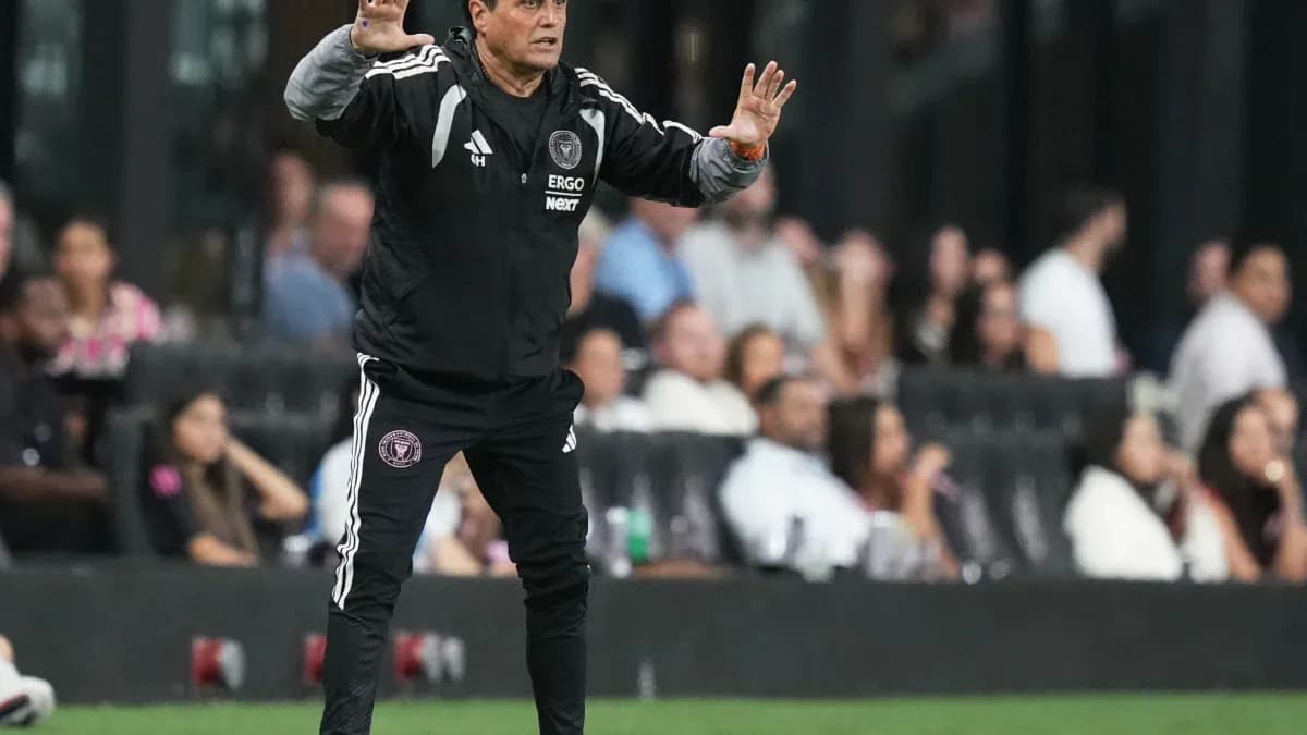 Coach gesturing from the sideline during match