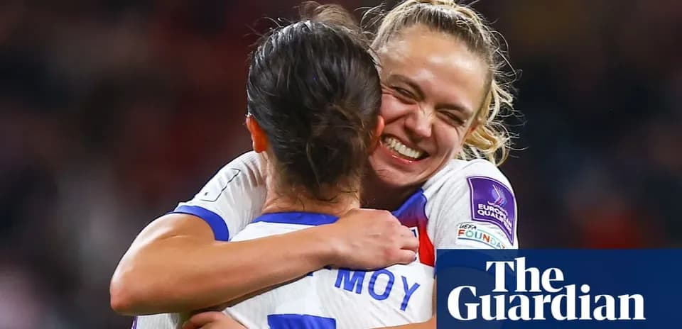 Players celebrating a goal with an embrace