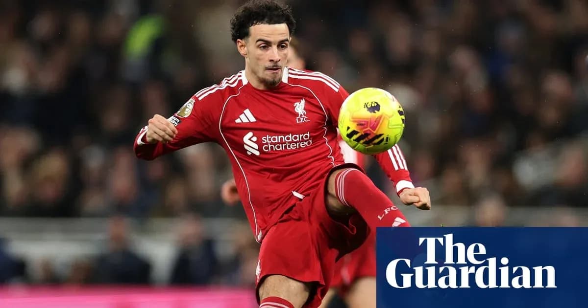 Liverpool player striking the ball during match