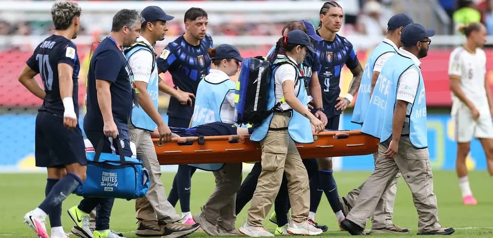 Medical team carrying player on stretcher off field