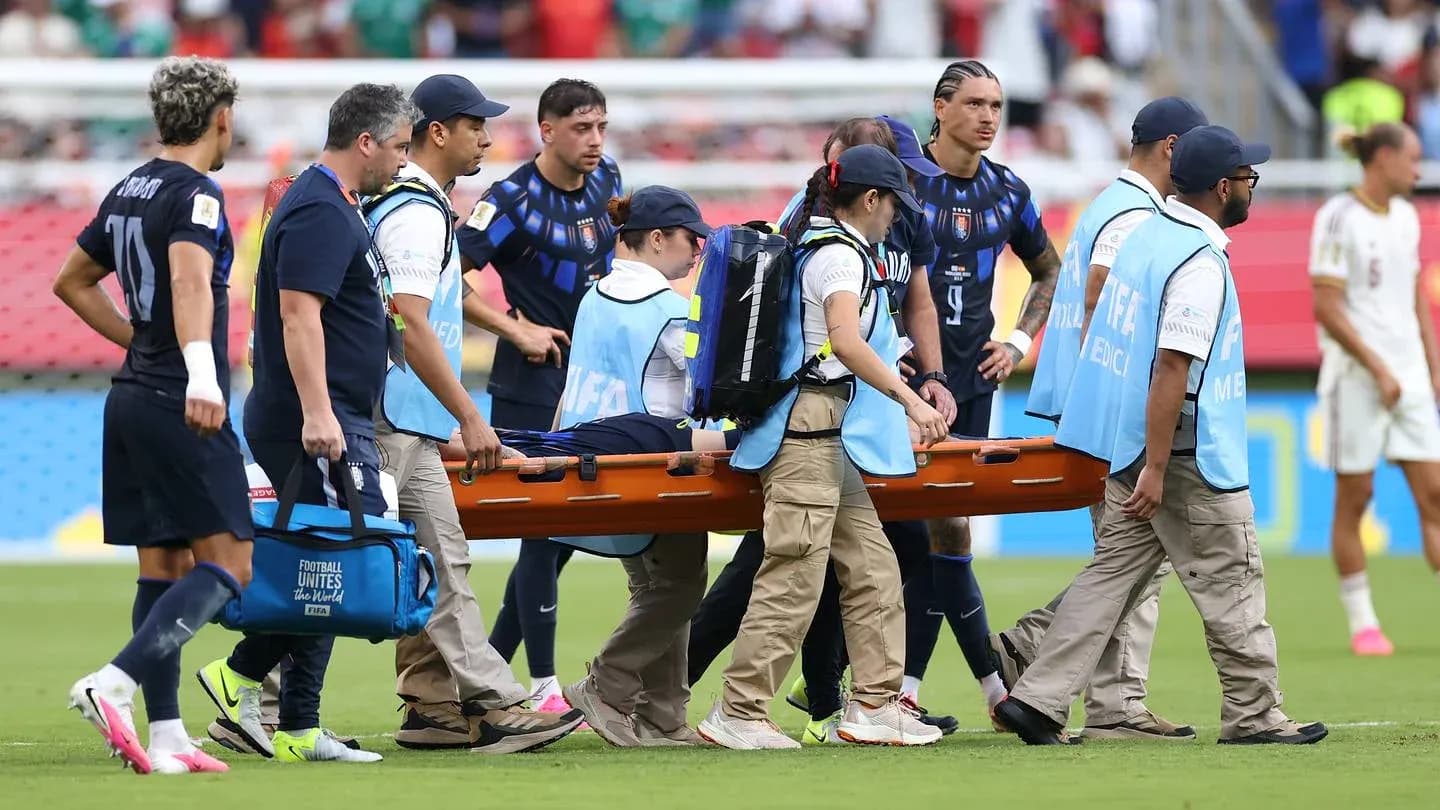 Medical team carrying player on stretcher off field