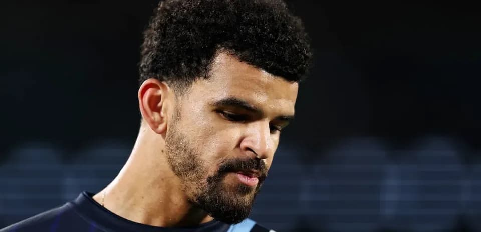 Football player looking down during match preparation