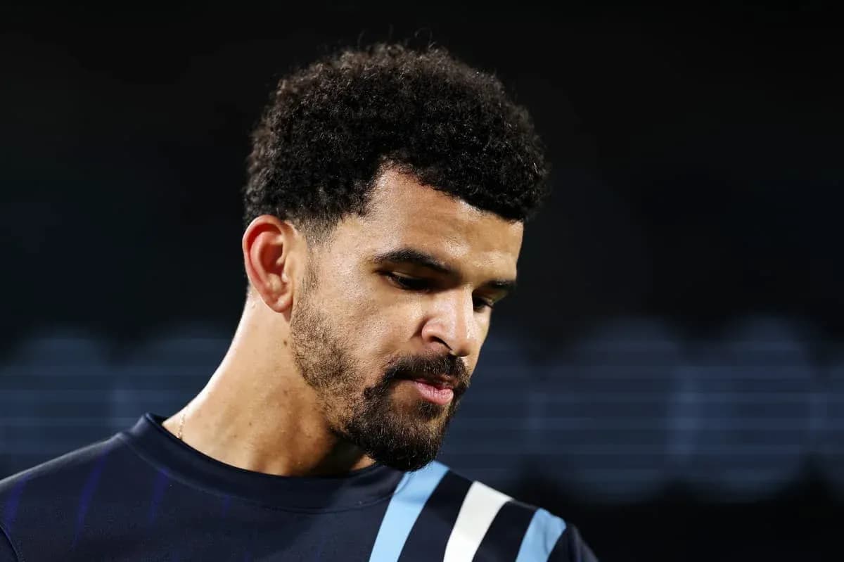 Football player looking down during match preparation