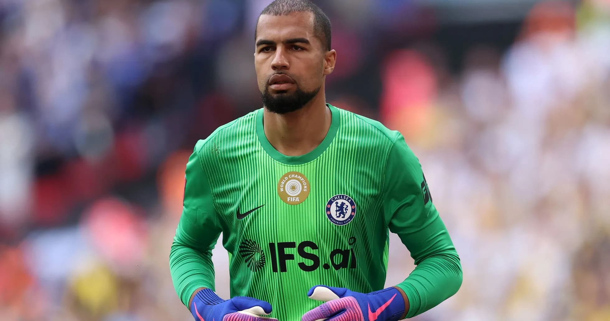 Goalkeeper in green kit preparing for match