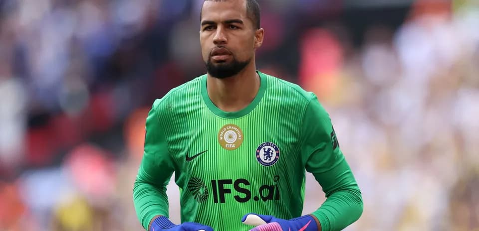 Goalkeeper in green kit preparing for match