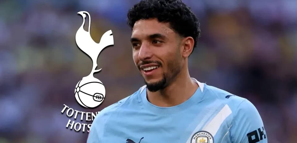 Player smiling in Manchester City jersey with logo