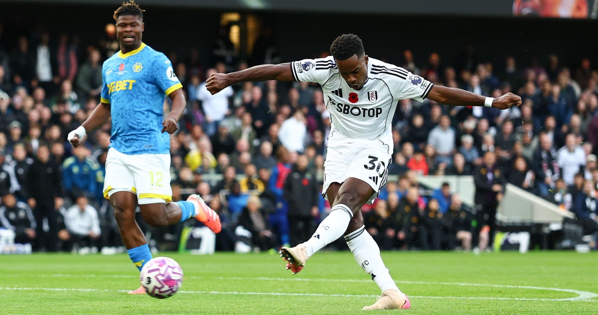 Fulham player striking the ball during match