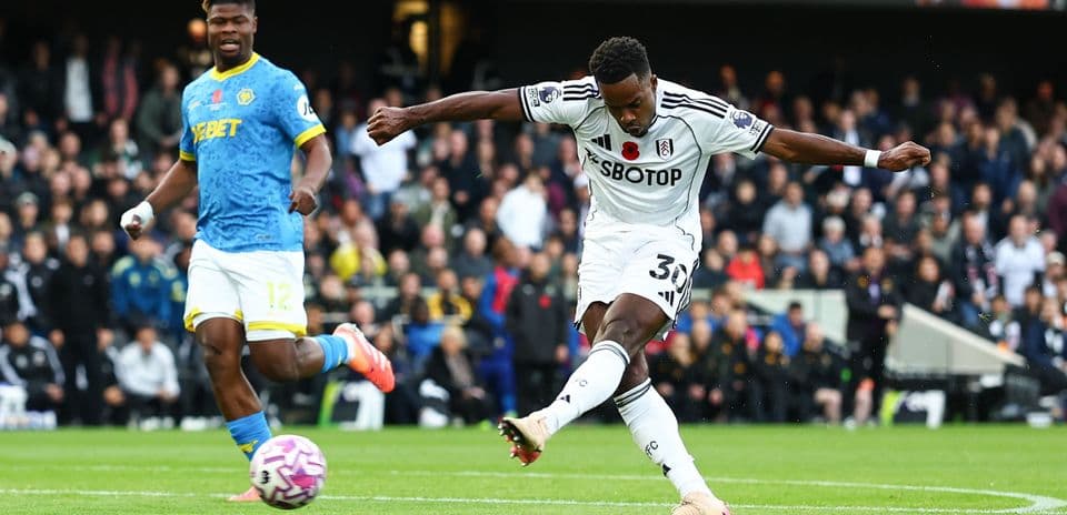 Fulham player striking the ball during match