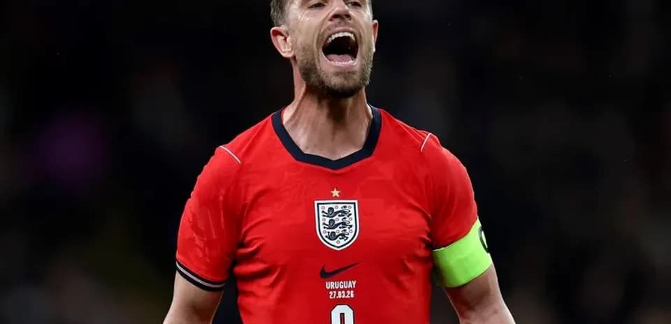 Player celebrating in England's red kit during match