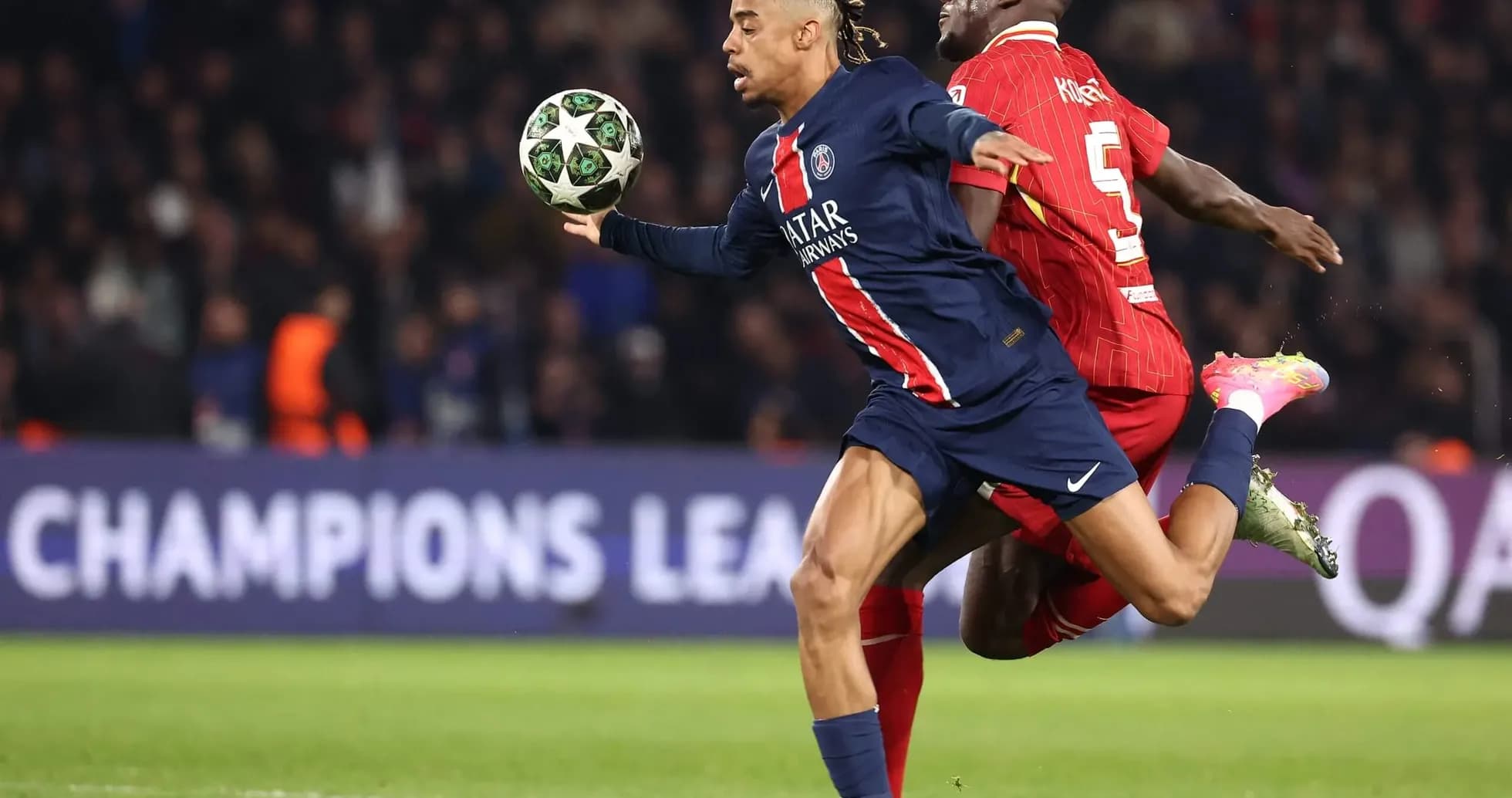 Player from PSG evading Liverpool defender