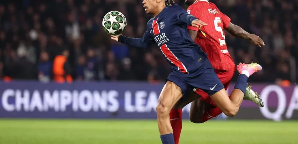 Player from PSG evading Liverpool defender