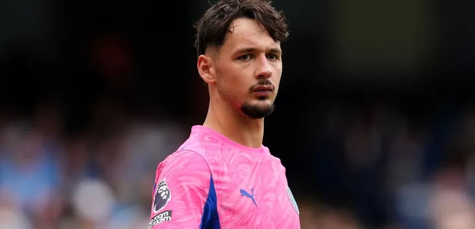 Goalkeeper in pink kit during match