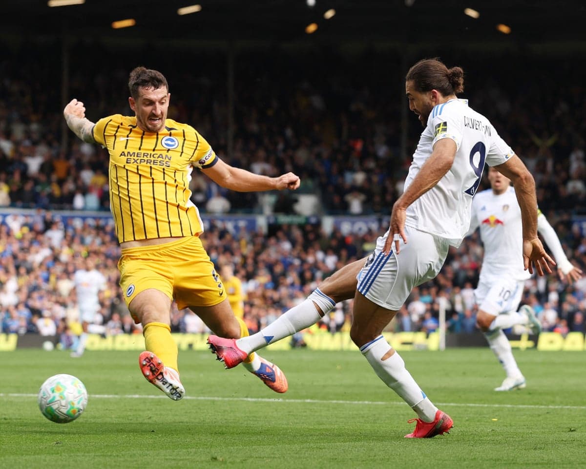 Leeds player tackling Brighton opponent during match