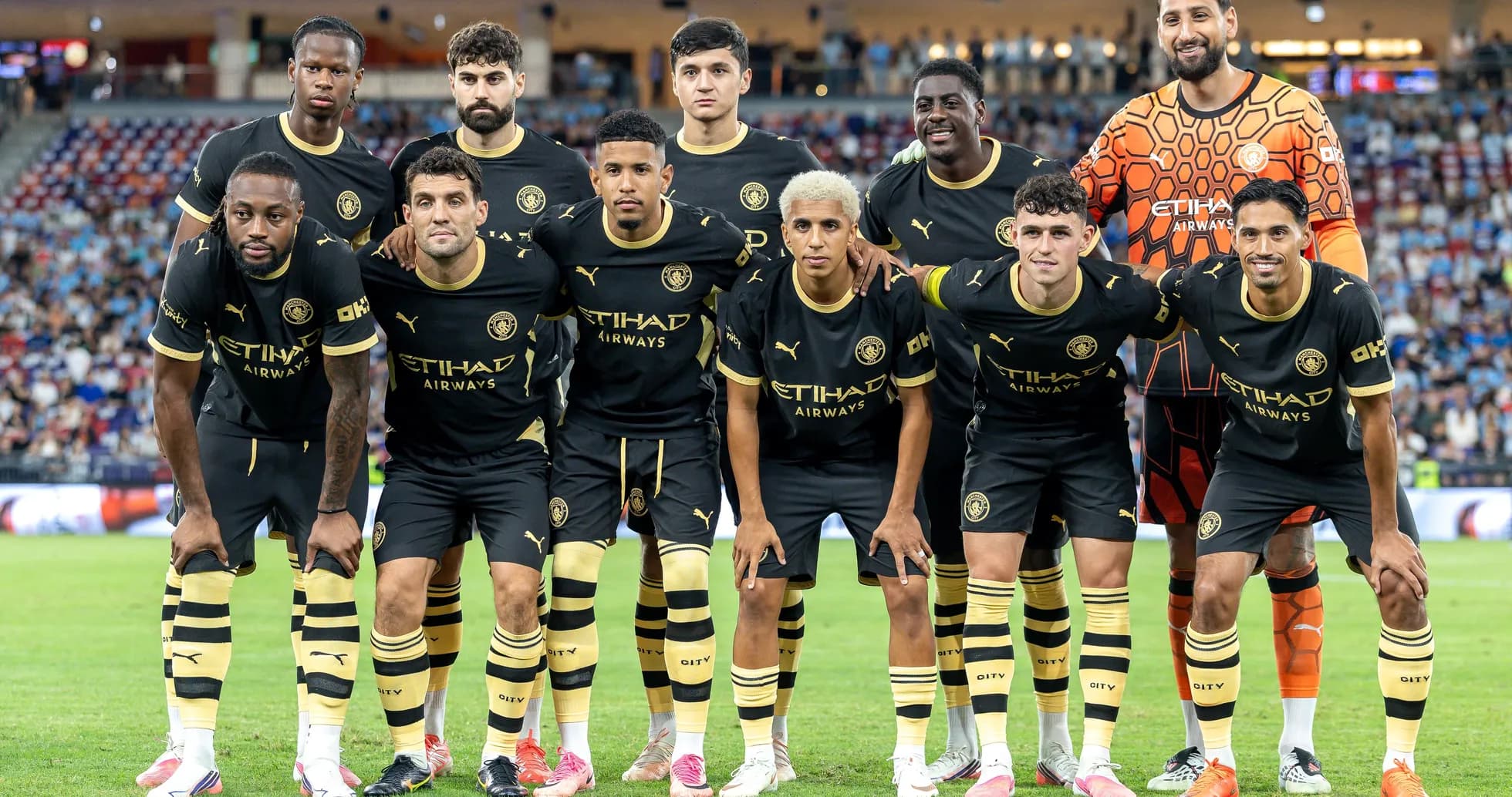 Football team posing for photo in black kits