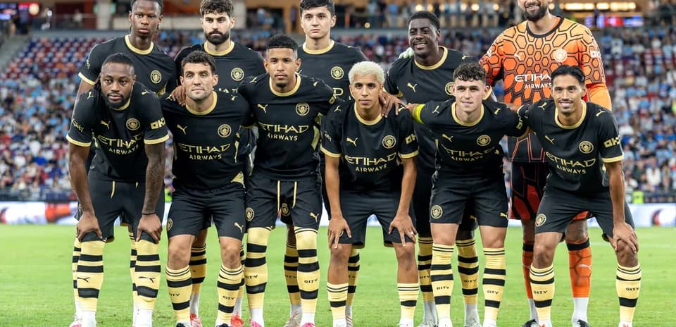 Football team posing for photo in black kits