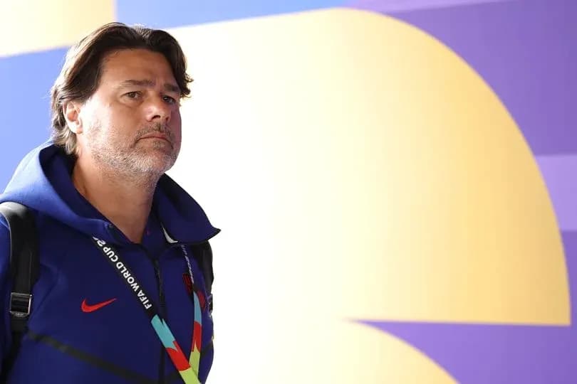 Coach entering venue wearing FIFA World Cup lanyard
