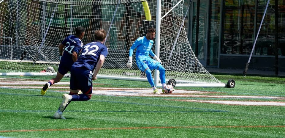 Goalkeeper preparing to make a save in match