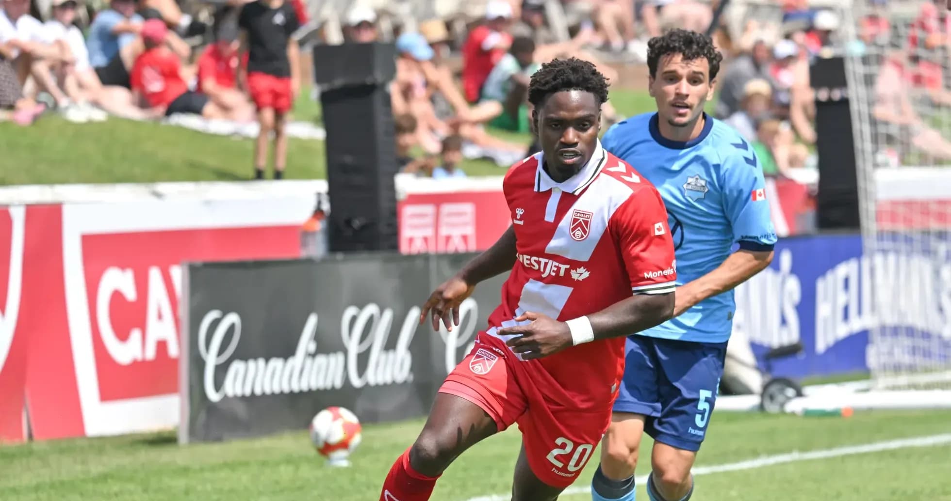 Cavalry FC player dribbling past HFX Wanderers FC player