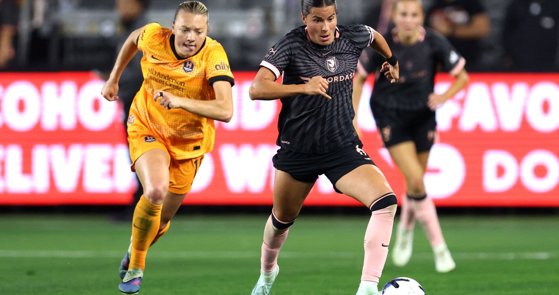 Houston Dash player dribbling past Angel City opponent