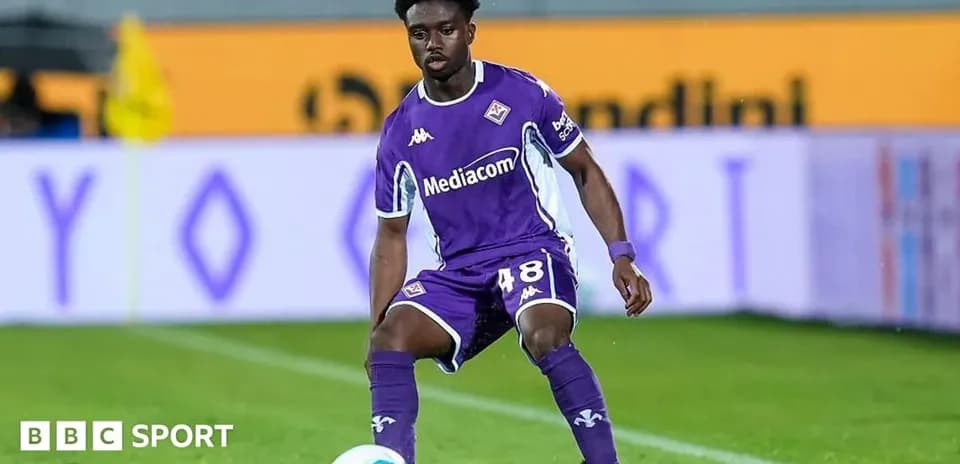 Player in purple kit preparing to pass ball