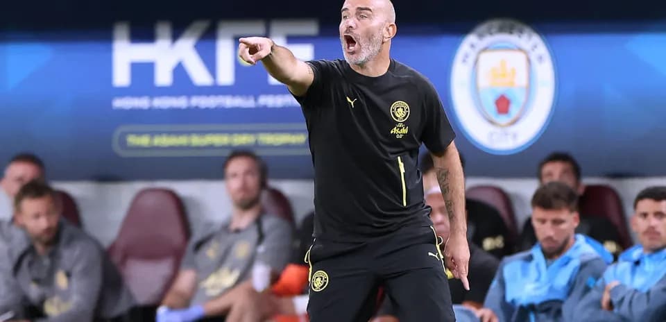 Coach instructing players from the sidelines during match