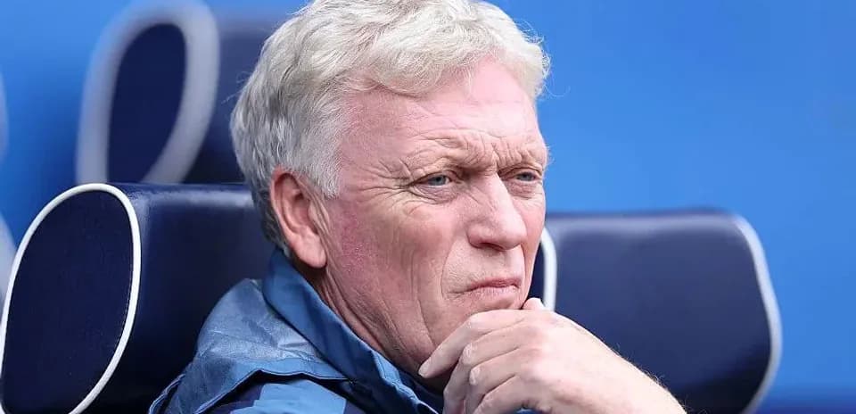 Coach seated on bench during match observation