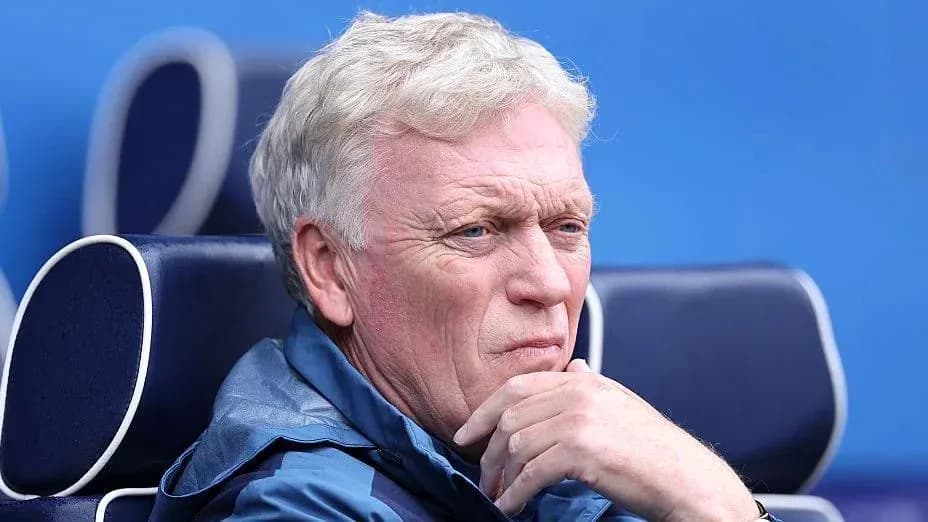 Coach seated on bench during match observation