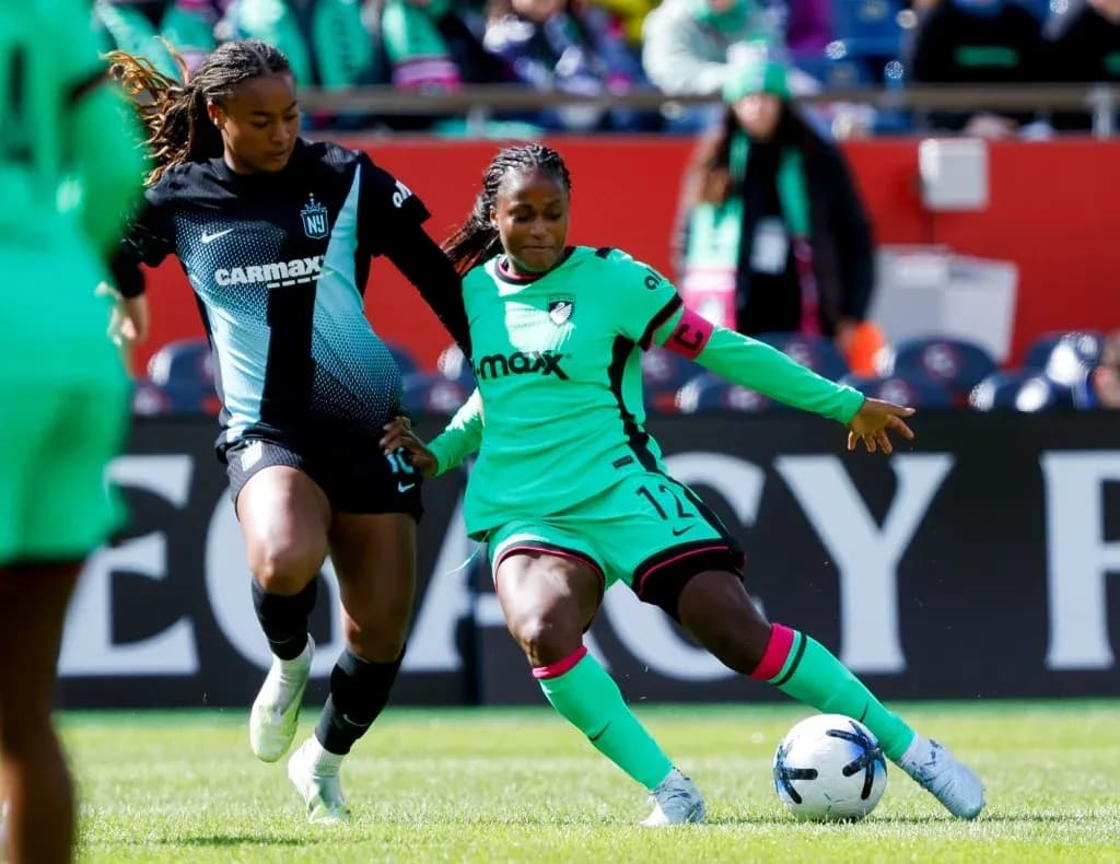 Players competing for the ball during NWSL match