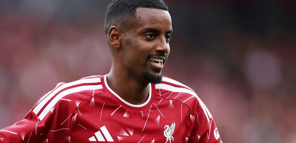 Player smiling in Liverpool training kit