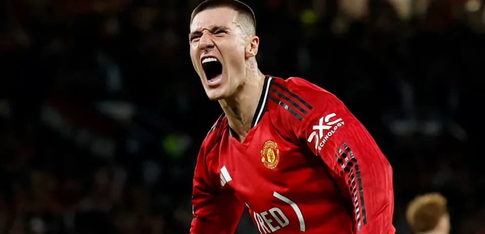 Player celebrating enthusiastically in Manchester United jersey