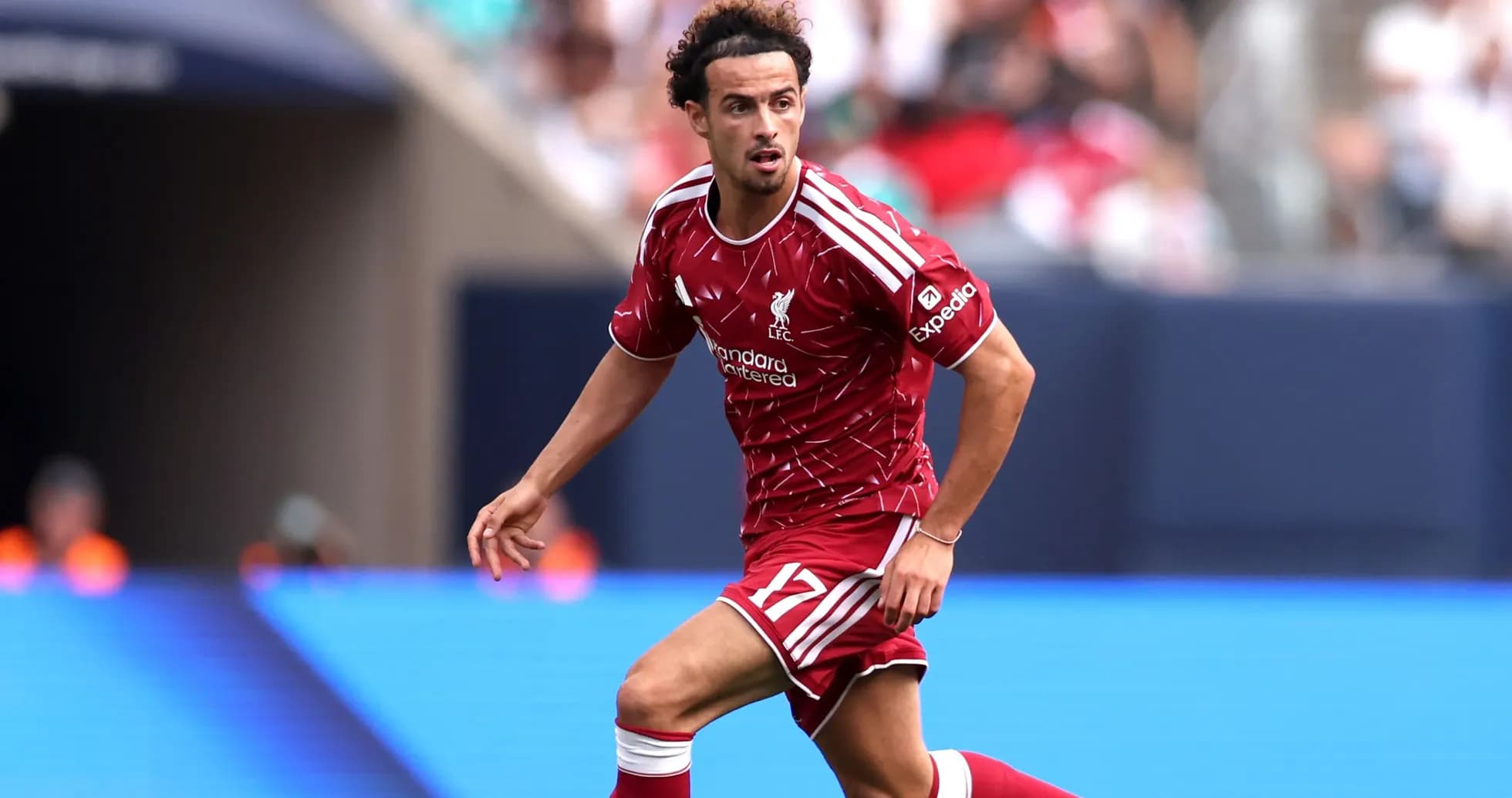 Player in Liverpool kit running on the field