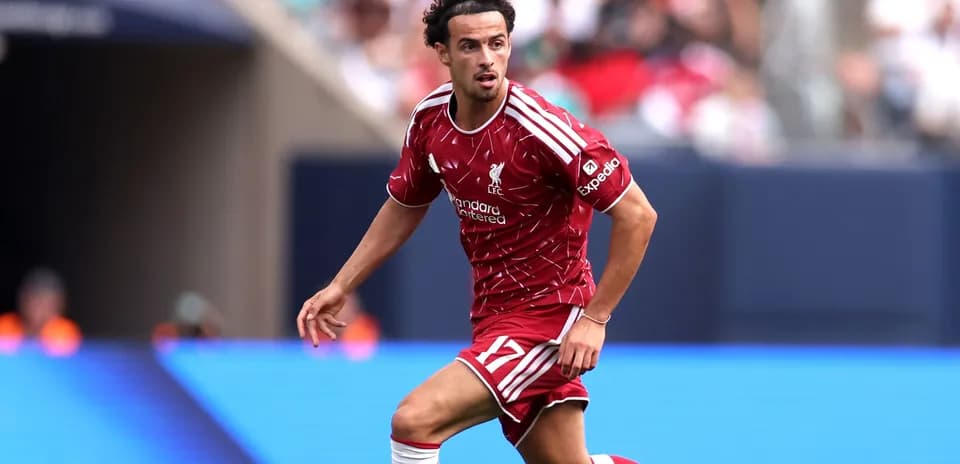 Player in Liverpool kit running on the field