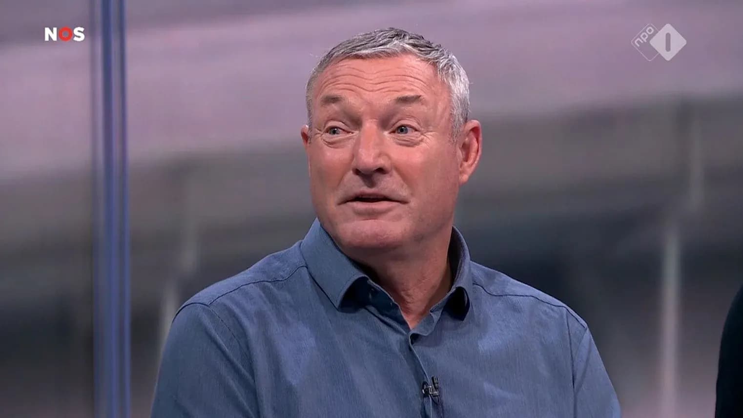 Man speaking during a television broadcast segment