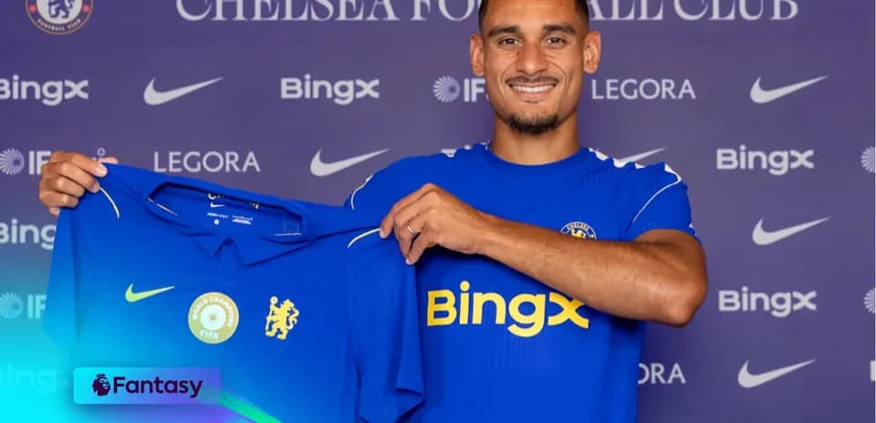 Player holding Chelsea FC jersey at presentation
