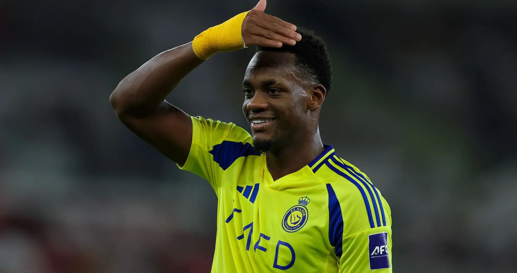 Player celebrating in yellow team jersey after match