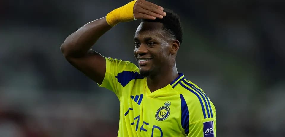 Player celebrating in yellow team jersey after match