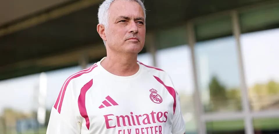 Coach wearing Real Madrid training kit outside facility