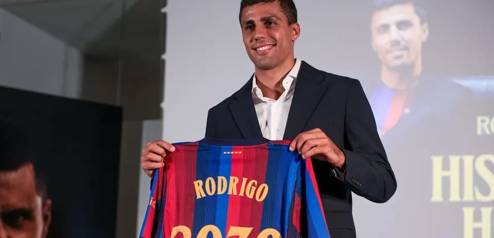 Player holding Barcelona jersey with name and number