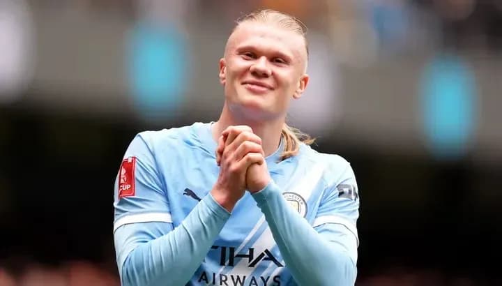 Player celebrating after a match wearing Manchester City kit