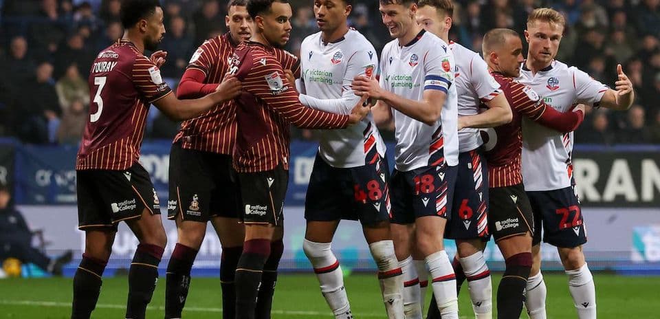Players from both teams engaging in a confrontation
