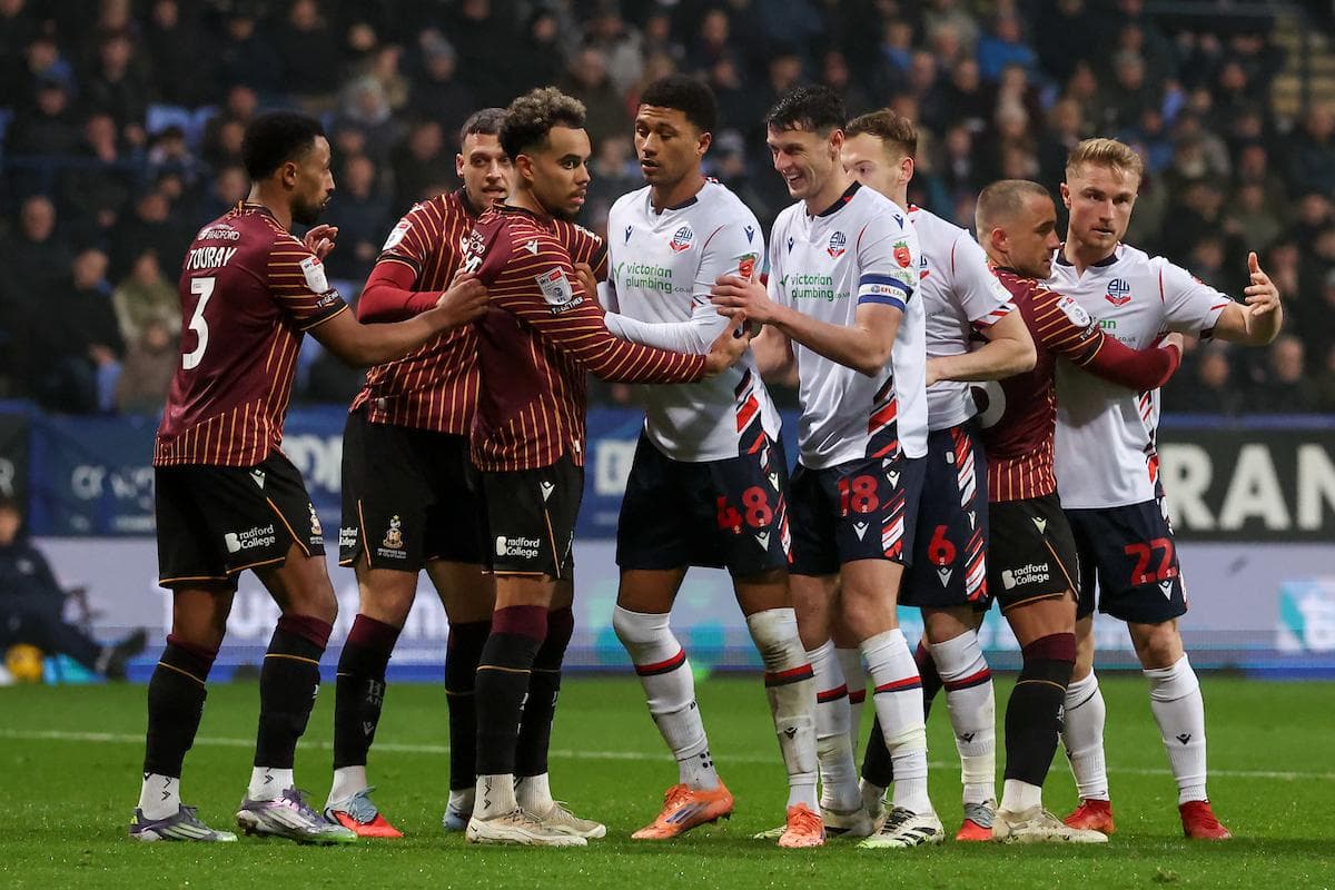 Players from both teams engaging in a confrontation